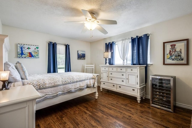 677 Fm 3356, Van Alstyne, TX 75495 - bedroom with wine cooler, dark wood-style flooring, a textured ceiling, a ceiling fan, and baseboards