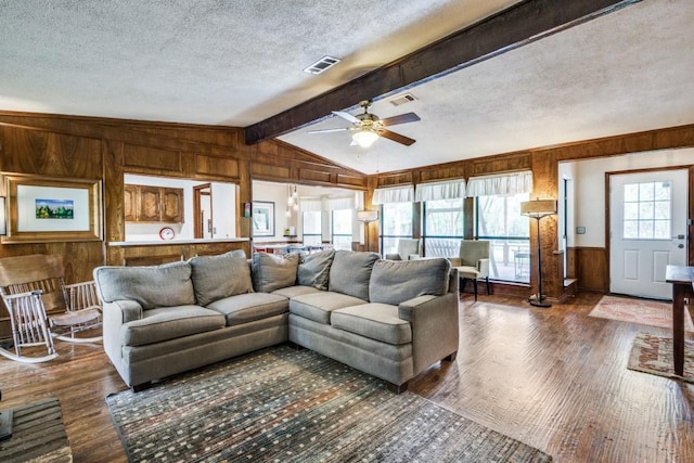 677 Fm 3356, Van Alstyne, TX 75495 - living area with wood walls, wood finished floors, a textured ceiling, and ceiling fan