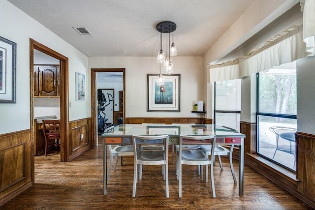 677 Fm 3356, Van Alstyne, TX 75495 - dining room with dark wood finished floors, a wainscoted wall, healthy amount of natural light, wood walls, and a textured ceiling