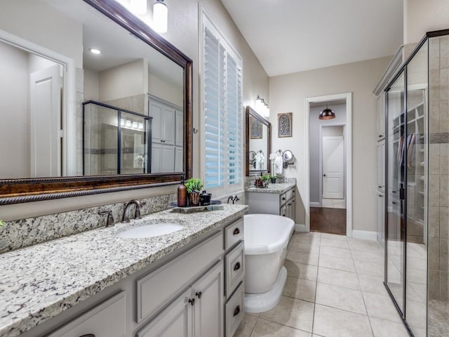 5717 Dr Kenneth Cooper Dr, Mckinney, TX 75070 - full bath featuring a stall shower, two vanities, a freestanding tub, and tile patterned floors