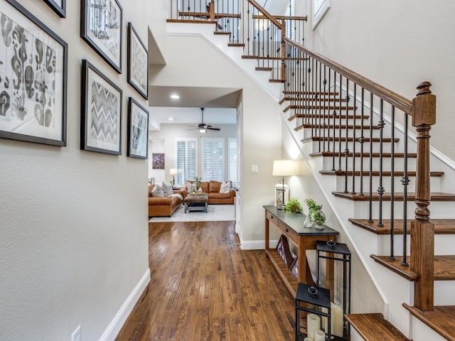5717 Dr Kenneth Cooper Dr, Mckinney, TX 75070 - staircase with wood finished floors, baseboards, a ceiling fan, and a high ceiling