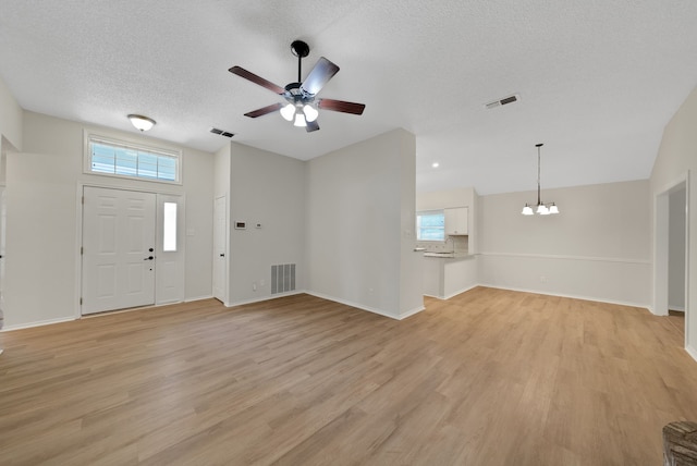 736 Lionel Way, Fort Worth, TX 76108 - entryway featuring a ceiling fan, light wood finished floors, a chandelier, a textured ceiling, and baseboards