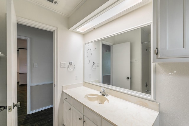 1510 Surry Place Dr, Cleburne, TX 76033 - full bathroom featuring vanity, crown molding, wood finished floors, and a shower