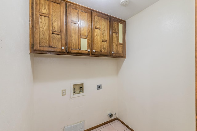 1510 Surry Place Dr, Cleburne, TX 76033 - washroom with cabinet space, washer hookup, hookup for an electric dryer, light tile patterned floors, and hookup for a gas dryer