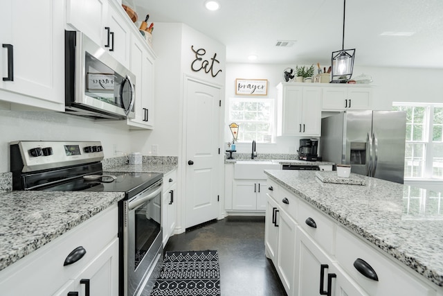 13530 Hiram Rd, Wills Point, TX 75169 - kitchen featuring stainless steel appliances, concrete flooring, white cabinets, light stone counters, and recessed lighting