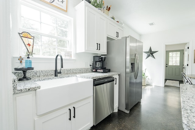13530 Hiram Rd, Wills Point, TX 75169 - kitchen featuring stainless steel appliances, white cabinets, a sink, baseboards, and light stone counters