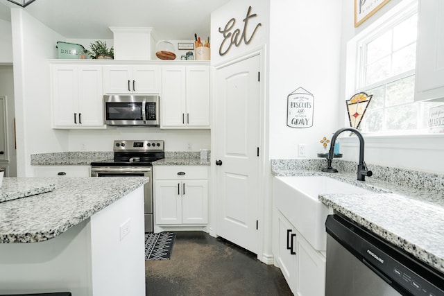 13530 Hiram Rd, Wills Point, TX 75169 - kitchen with stainless steel appliances, finished concrete floors, white cabinetry, light stone countertops, and a sink