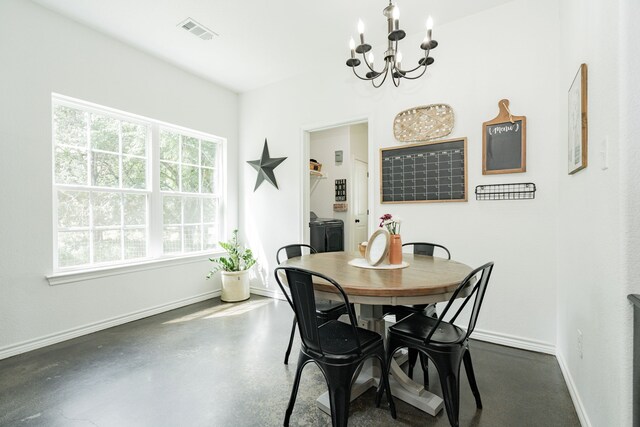 13530 Hiram Rd, Wills Point, TX 75169 - dining area with a chandelier, baseboards, and finished concrete floors