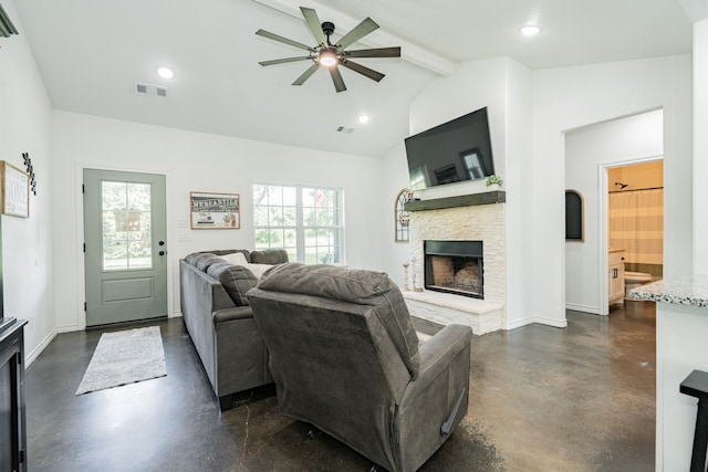 13530 Hiram Rd, Wills Point, TX 75169 - living room with finished concrete floors, beamed ceiling, a ceiling fan, a stone fireplace, and baseboards