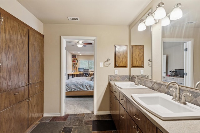 5020 Timber Creek Rd, Flower Mound, TX 75028 - ensuite bathroom featuring double vanity, stone finish flooring, baseboards, and ceiling fan