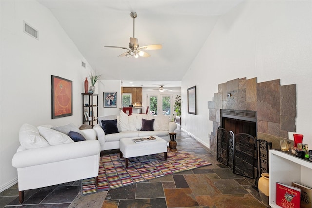 5020 Timber Creek Rd, Flower Mound, TX 75028 - living room featuring stone tile floors, a ceiling fan, high vaulted ceiling, a tiled fireplace, and baseboards