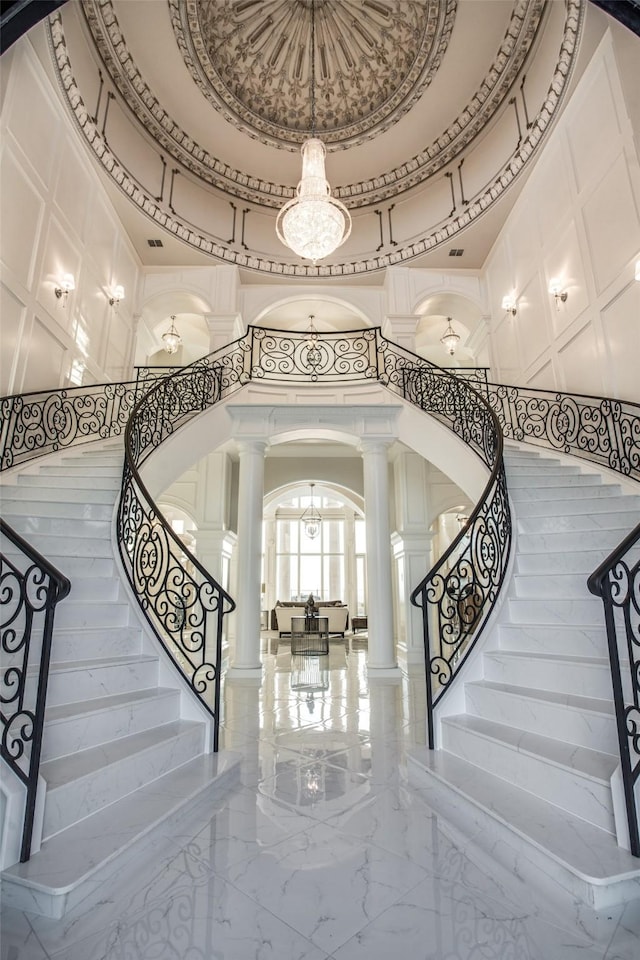 2449 Mountain View Ct, Cedar Hill, TX 75104 - foyer with arched walkways, ornate columns, a chandelier, a towering ceiling, and marble tiled floors