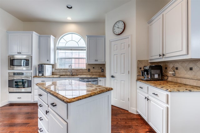 7905 Cherry Creek Dr, Plano, TX 75025 - kitchen featuring appliances with stainless steel finishes, a sink, light stone countertops, dark wood-style floors, and recessed lighting
