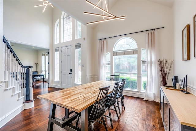7905 Cherry Creek Dr, Plano, TX 75025 - dining space featuring dark wood-style floors, high vaulted ceiling, and stairs