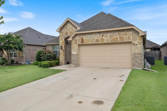 612 Redwood Dr, Greenville, TX 75402 - french provincial home with central AC, driveway, an attached garage, brick siding, and stone siding