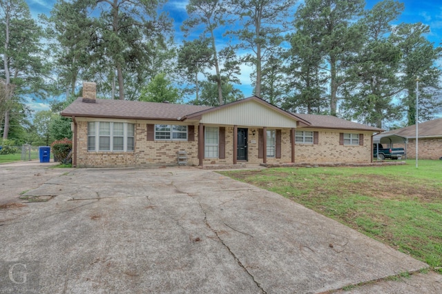2031 Beth Ln, Shreveport, LA 71118 - single story home with brick siding, a chimney, a front lawn, and concrete driveway