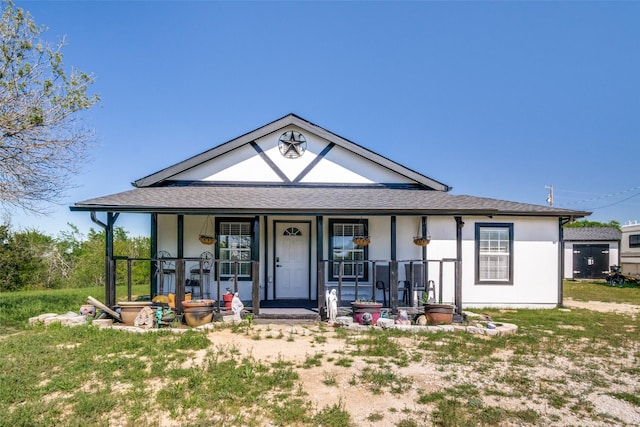 6980 Prather Rd, Springtown, TX 76082 - view of front facade with a porch, stucco siding, and roof with shingles