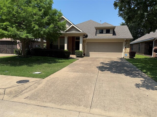 2816 Lacompte Dr, Dallas, TX 75227 - view of front of house with a front lawn, driveway, stone siding, and a shingled roof