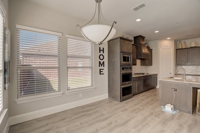 1305 Xeraco Dr, Little Elm, TX 75068 - kitchen featuring a sink, custom range hood, plenty of natural light, stainless steel appliances, and recessed lighting