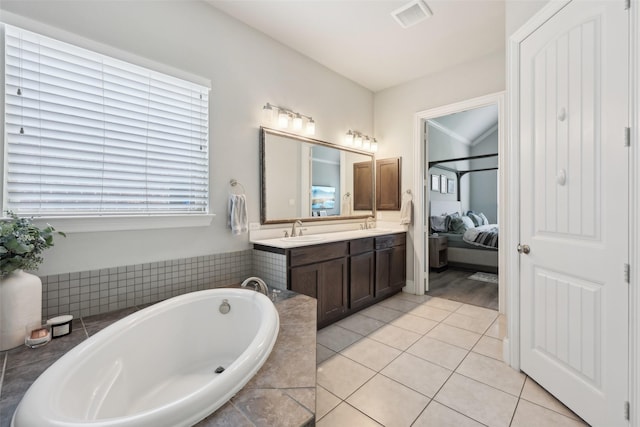 1305 Xeraco Dr, Little Elm, TX 75068 - ensuite bathroom featuring double vanity, a bath, and tile patterned flooring
