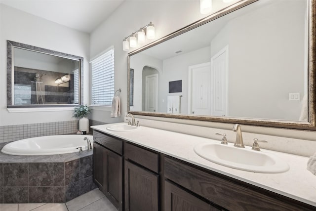 1305 Xeraco Dr, Little Elm, TX 75068 - bathroom with double vanity, tile patterned flooring, and a bath