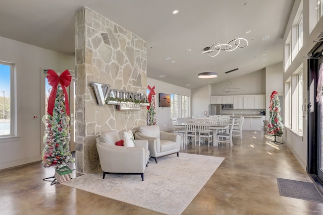 1305 Xeraco Dr, Little Elm, TX 75068 - living room with finished concrete flooring, baseboards, and a towering ceiling