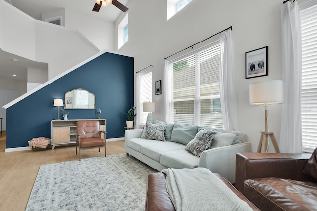 1356 Portsmouth Dr, Providence Village, TX 76227 - living room with ceiling fan, healthy amount of natural light, wood finished floors, a towering ceiling, and baseboards