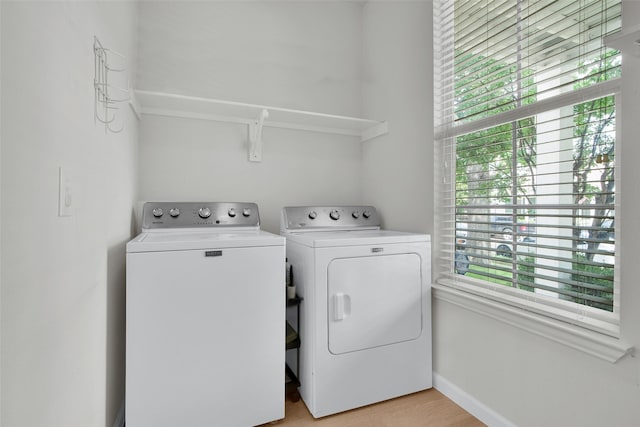 1356 Portsmouth Dr, Providence Village, TX 76227 - laundry area with washer and clothes dryer, baseboards, and light wood finished floors