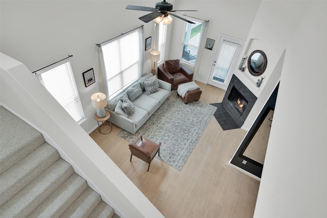 1356 Portsmouth Dr, Providence Village, TX 76227 - living room with a ceiling fan, a high ceiling, wood finished floors, and a fireplace