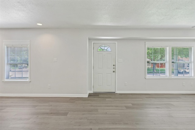 1320 Dale Dr, Garland, TX 75041 - entrance foyer with a textured ceiling, wood finished floors, baseboards, and recessed lighting