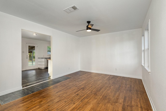 111 Leighton Dr, Terrell, TX 75160 - spare room featuring dark wood-style floors, baseboards, and ceiling fan