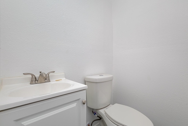 111 Leighton Dr, Terrell, TX 75160 - bathroom with toilet, vanity, and a textured wall