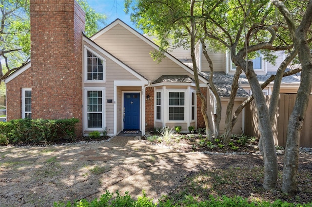 17820 Windflower Way Unit 503, Dallas, TX 75252 - view of front of home with a chimney and brick siding