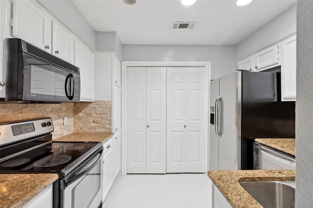 17820 Windflower Way Unit 503, Dallas, TX 75252 - kitchen with appliances with stainless steel finishes, white cabinets, light stone counters, backsplash, and light tile patterned floors