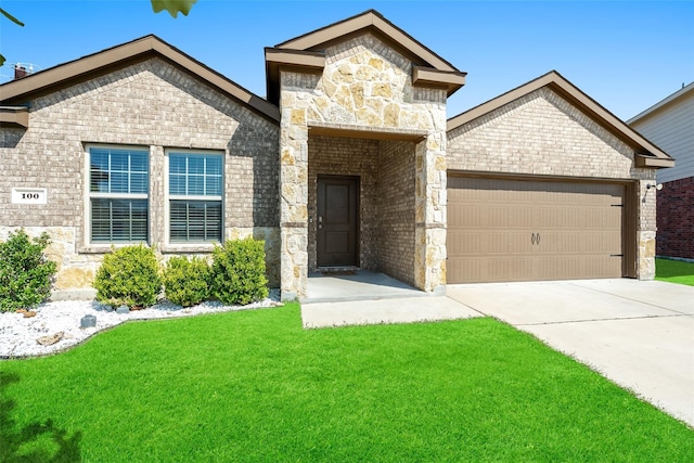 100 Samuel St, Denton, TX 76207 - french country style house featuring an attached garage, concrete driveway, a front yard, and brick siding