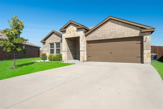 100 Samuel St, Denton, TX 76207 - view of front of house featuring stone siding, a garage, driveway, central AC unit, and brick siding