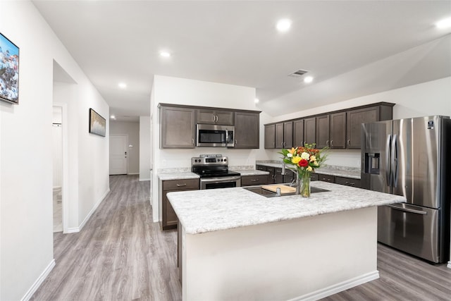 100 Samuel St, Denton, TX 76207 - kitchen featuring stainless steel appliances, a sink, dark brown cabinets, light wood-type flooring, and recessed lighting