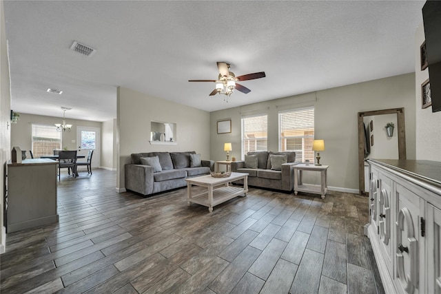 552 Lincoln Ave, Lavon, TX 75166 - living room featuring dark wood-style flooring, ceiling fan, a chandelier, and baseboards