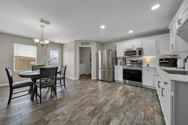 552 Lincoln Ave, Lavon, TX 75166 - kitchen featuring stainless steel appliances, a chandelier, light countertops, washer and dryer, and a sink
