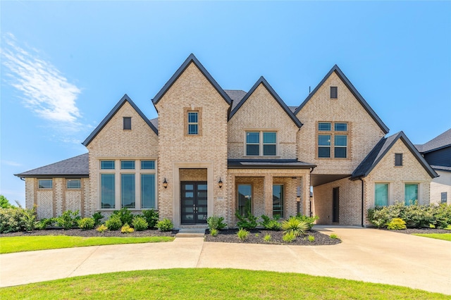 2130 Lassen Dr, Prosper, TX 75078 - view of front of house with brick siding and french doors