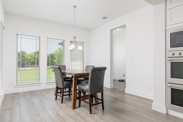 2130 Lassen Dr, Prosper, TX 75078 - dining area with a chandelier, light wood-style flooring, and baseboards