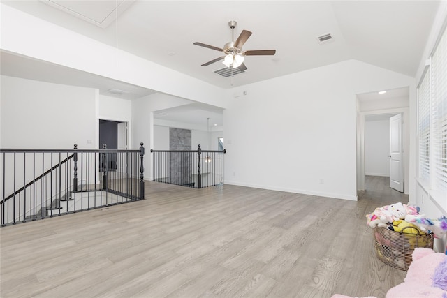 2130 Lassen Dr, Prosper, TX 75078 - unfurnished living room with attic access, wood finished floors, vaulted ceiling, a ceiling fan, and baseboards