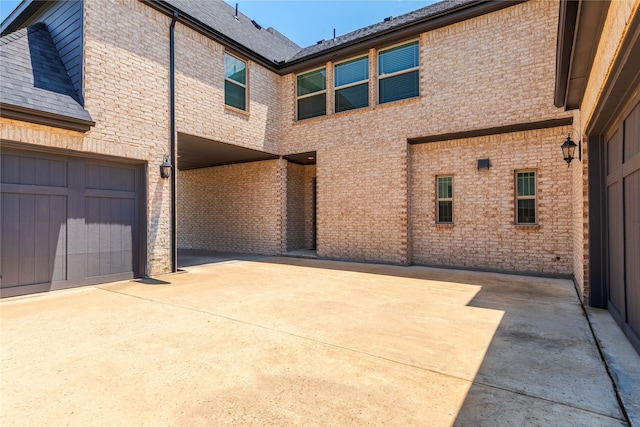 2130 Lassen Dr, Prosper, TX 75078 - back of house with brick siding, driveway, and roof with shingles