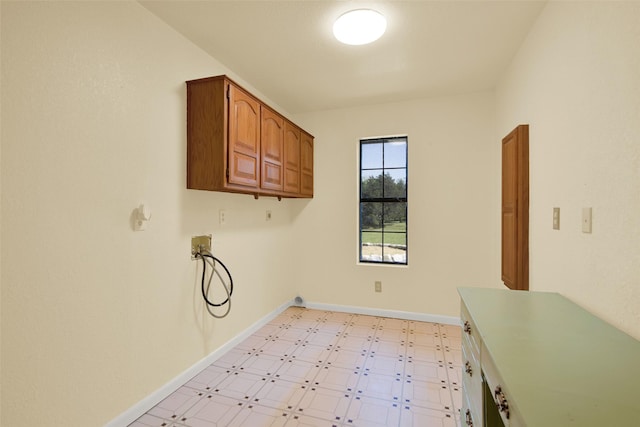 492 Russell Ln, Denison, TX 75021 - laundry area with washer hookup, cabinet space, light floors, and baseboards