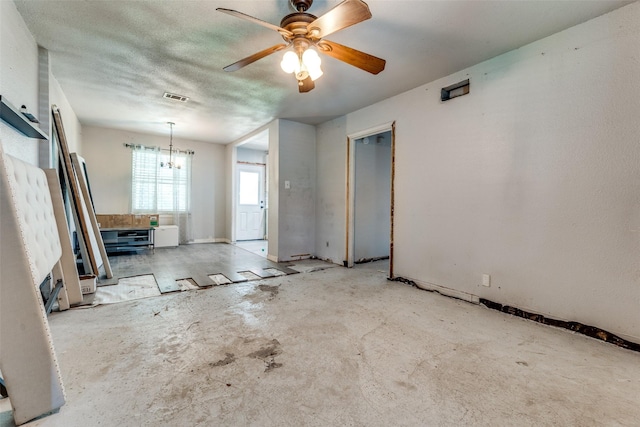 7719 Seydel St, Dallas, TX 75217 - unfurnished living room featuring ceiling fan, concrete floors, and a chandelier