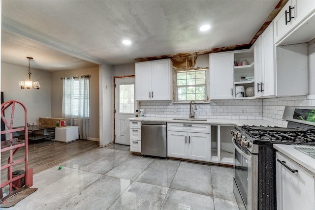 7719 Seydel St, Dallas, TX 75217 - kitchen featuring appliances with stainless steel finishes, a sink, light countertops, white cabinets, and backsplash