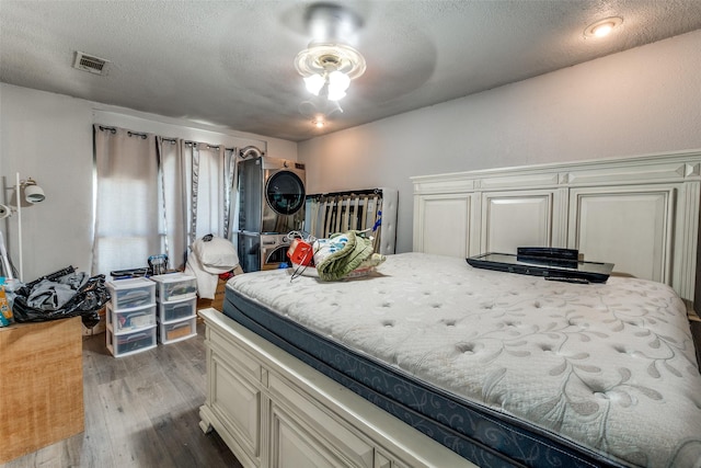 7719 Seydel St, Dallas, TX 75217 - bedroom featuring wood finished floors and a textured ceiling