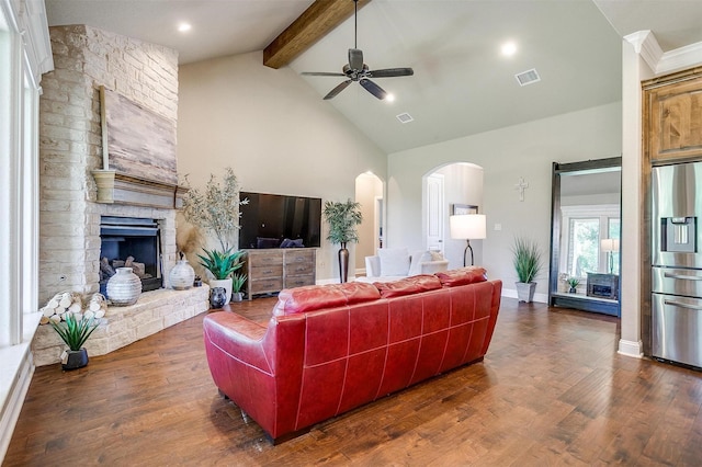 3201 Steamers Ct, Granbury, TX 76049 - living area with arched walkways, a stone fireplace, ceiling fan, high vaulted ceiling, and beam ceiling