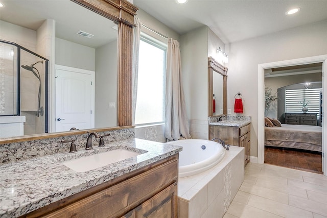 3201 Steamers Ct, Granbury, TX 76049 - bathroom with a jetted tub, two vanities, healthy amount of natural light, a shower stall, and recessed lighting