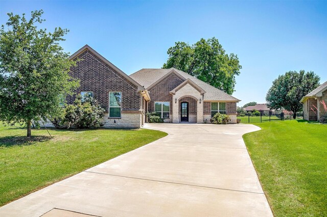 3201 Steamers Ct, Granbury, TX 76049 - french country inspired facade featuring brick siding and concrete driveway